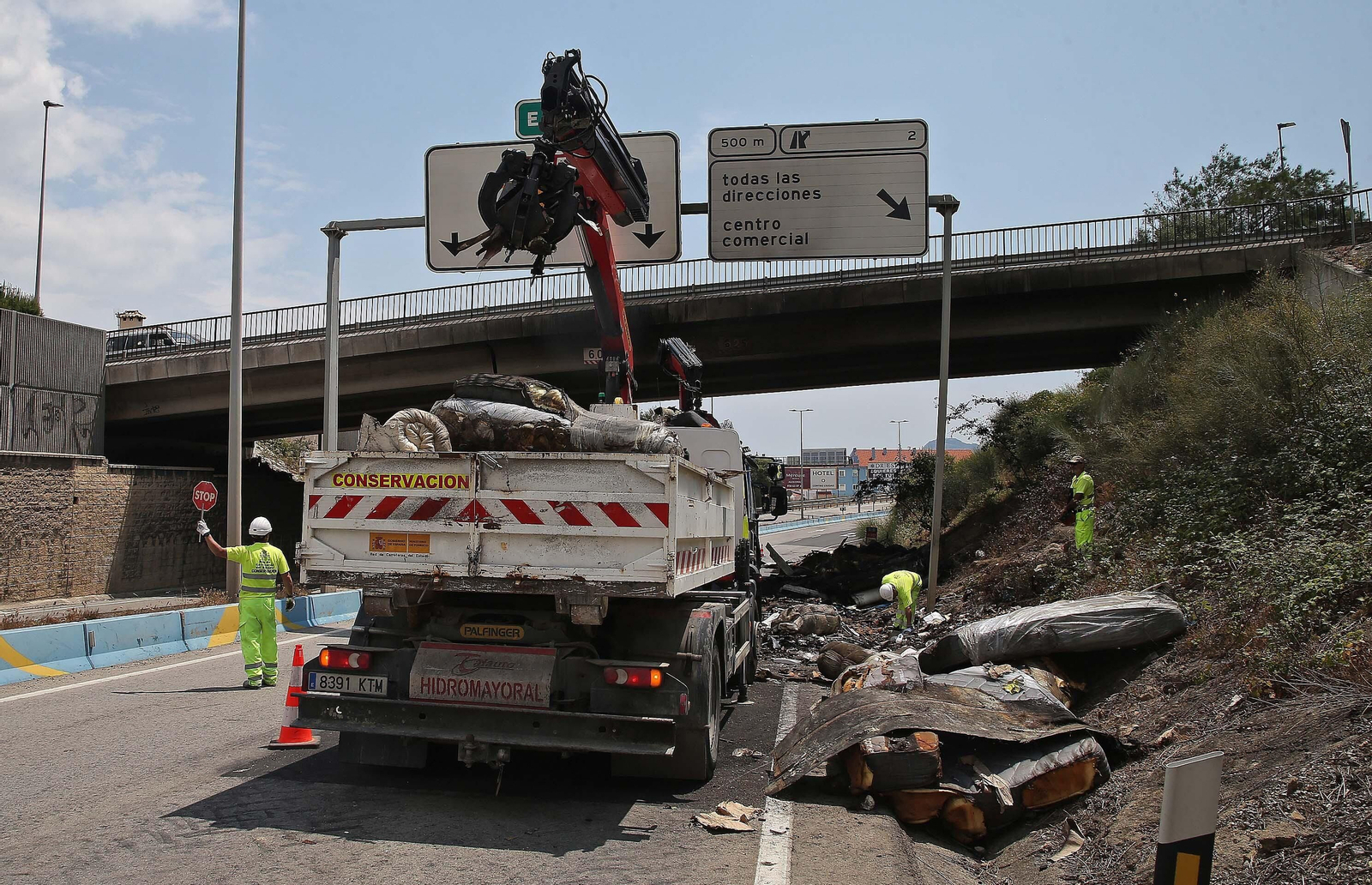 Fotos de la retirada de la carga del camión incendiado en el acceso norte de Algeciras