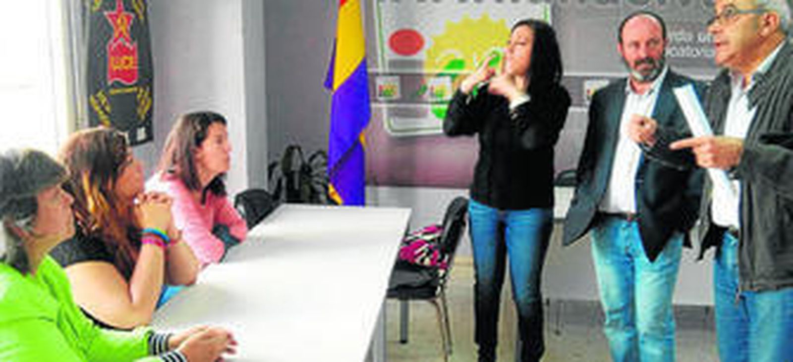 Fátima López, Águeda Millán y Cinta Masegosa, directivas de la asociación, siguen las palabras del componente de la lista de IU en la capital, Manuel Crespo, a través de una intérprete de la lengua de signos, en presencia del candidato izquierdista, Pedro Jiménez, durante la reunión celebrada ayer.