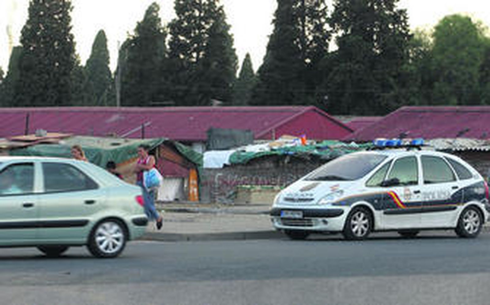 Un patrullero de la Policía Nacional, detenido en la rotonda de entrada al asentamiento chabolista del Vacie.