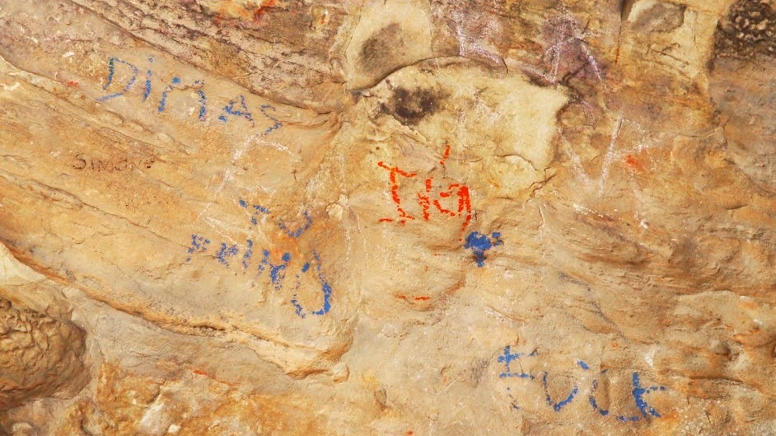 Grafitis sobre las pinturas rupestres de la cueva del Arca.