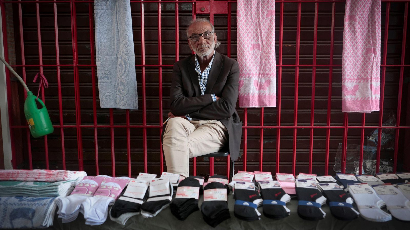 Un hombre vende calcetines en una galería comercial del barrio.