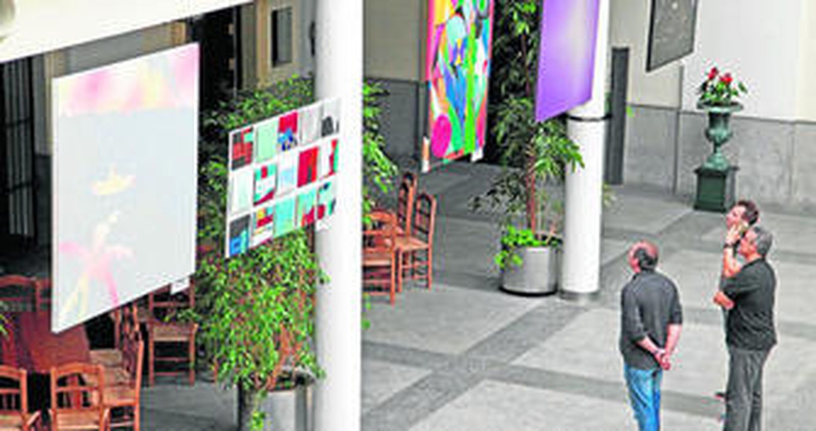Un grupo de personas observa ayer algunas de las obras expuestas en el Salón Valdespino de las Bodegas Estévez.