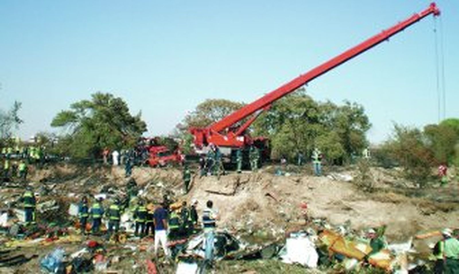 Bomberos y agentes de la Guardia Civil inspeccionan el lugar el día del accidente.