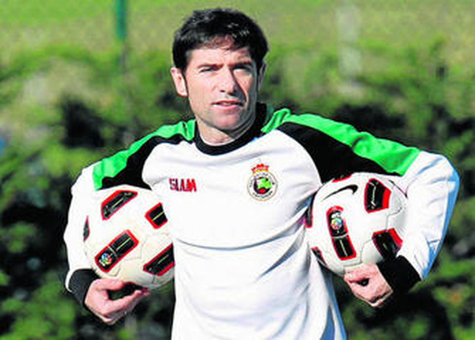 Marcelino sostiene dos balones durante un entrenamiento con el Racing de Santander.