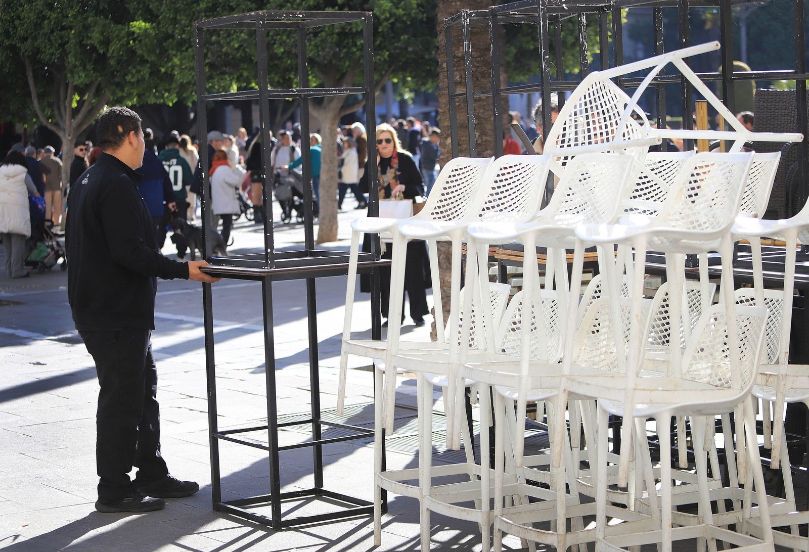 Un hombre, colocando la terraza de un bar en este mes.