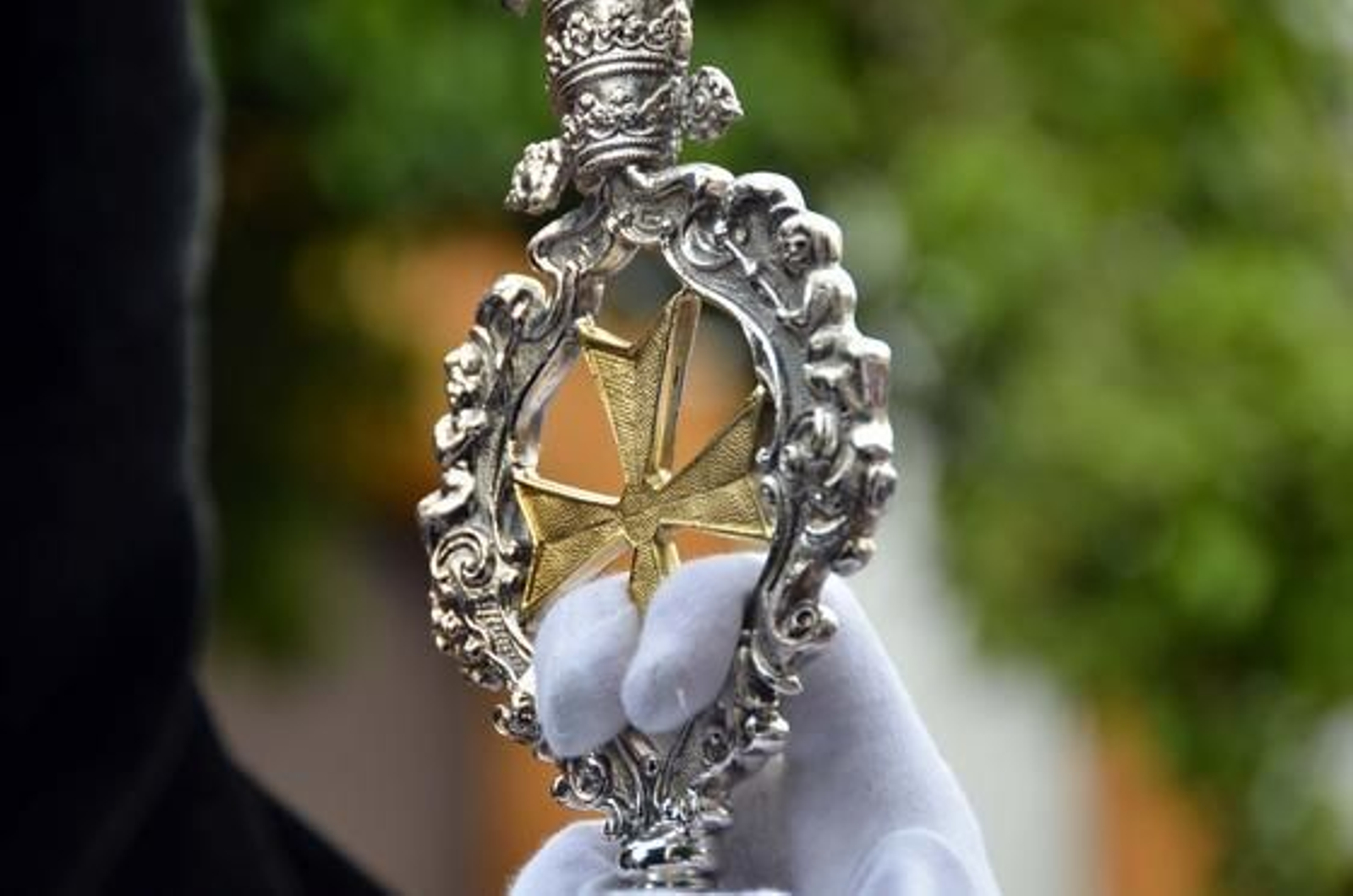Primera plano de una vara de la Hermandad de la Coronación sostenida por un hermano.

Foto: Manuel Aranda