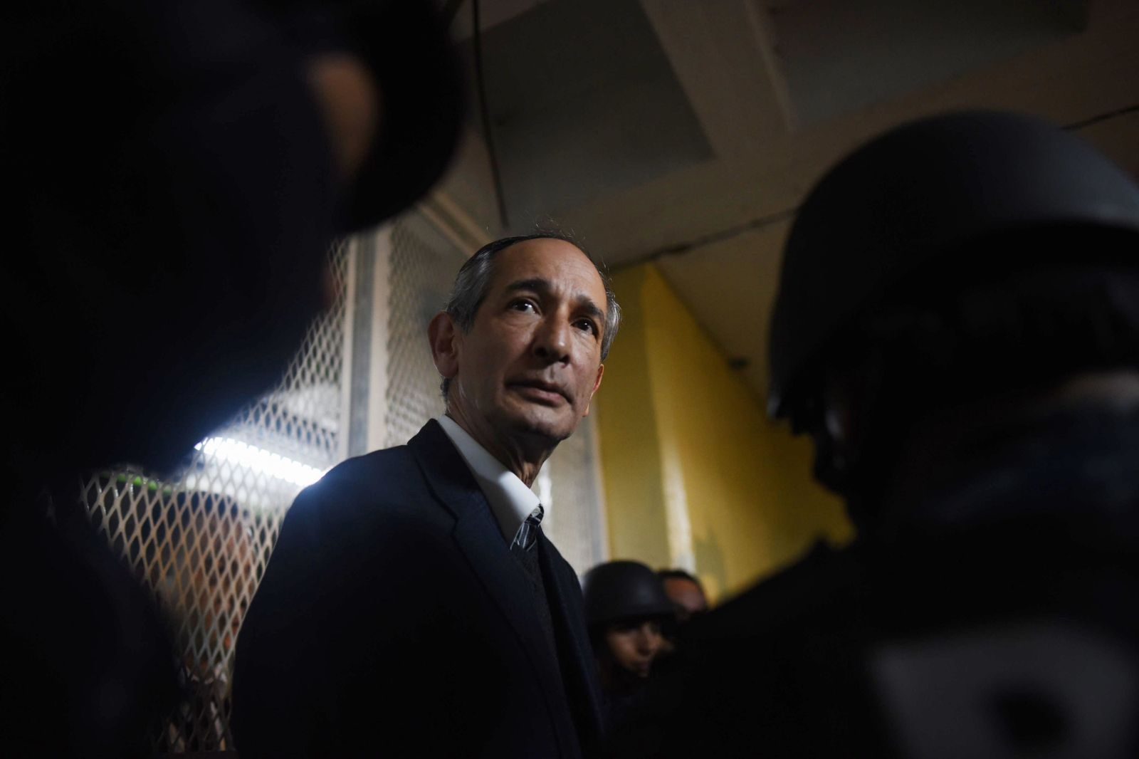 El ex presidente de Guatemala Álvaro Colom camina escoltado tras ser capturado.