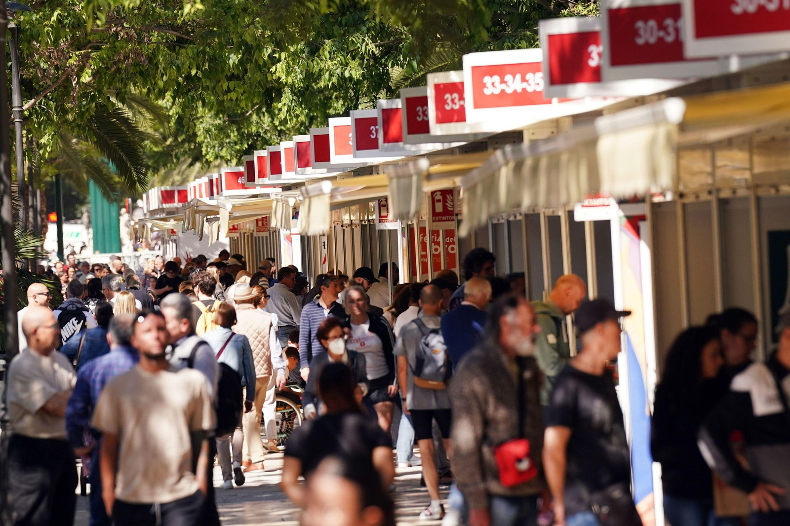 Visitantes junto a las casetas de la Feria del Libro.