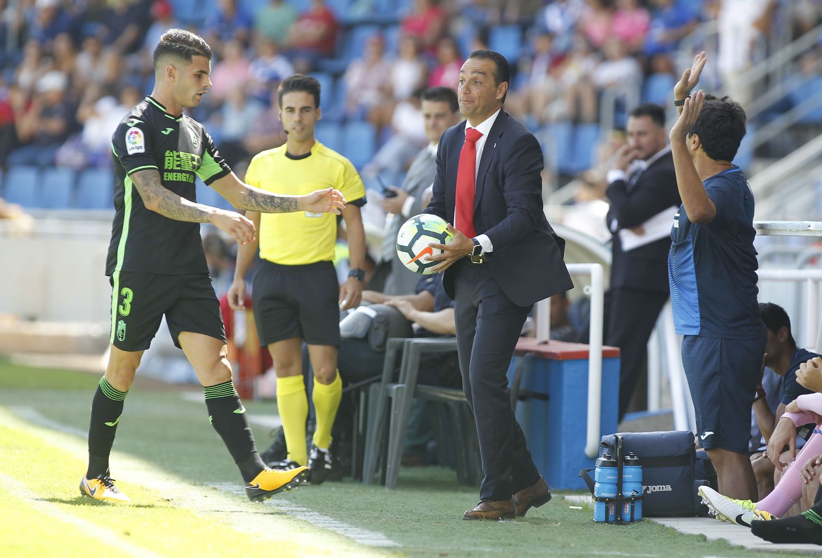 Oltra sostiene el balón para dárselo a Álex Martínez.