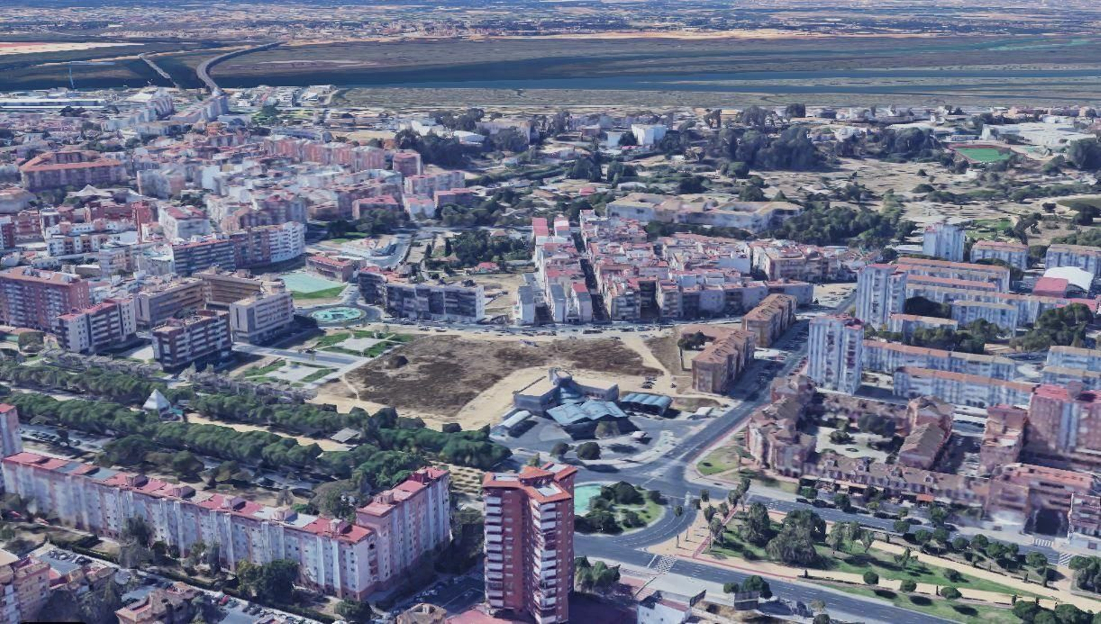 Vista aérea de la barriada con el gran solar destinado a uso comercial y terciario.