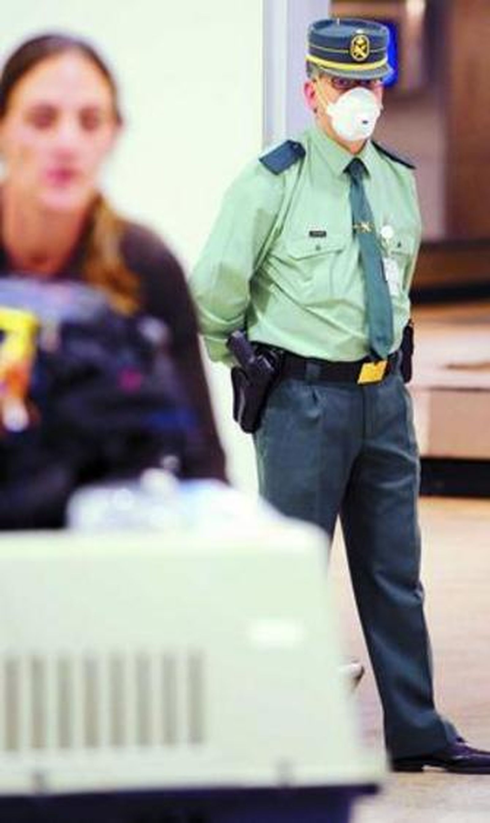 Una viajera y un guardia civil, ayer, en Barajas.