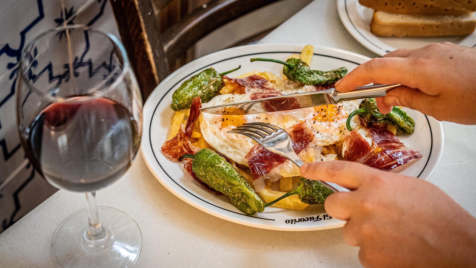 Huevos fritos con jamon, pimiento de Padrón y patatas.