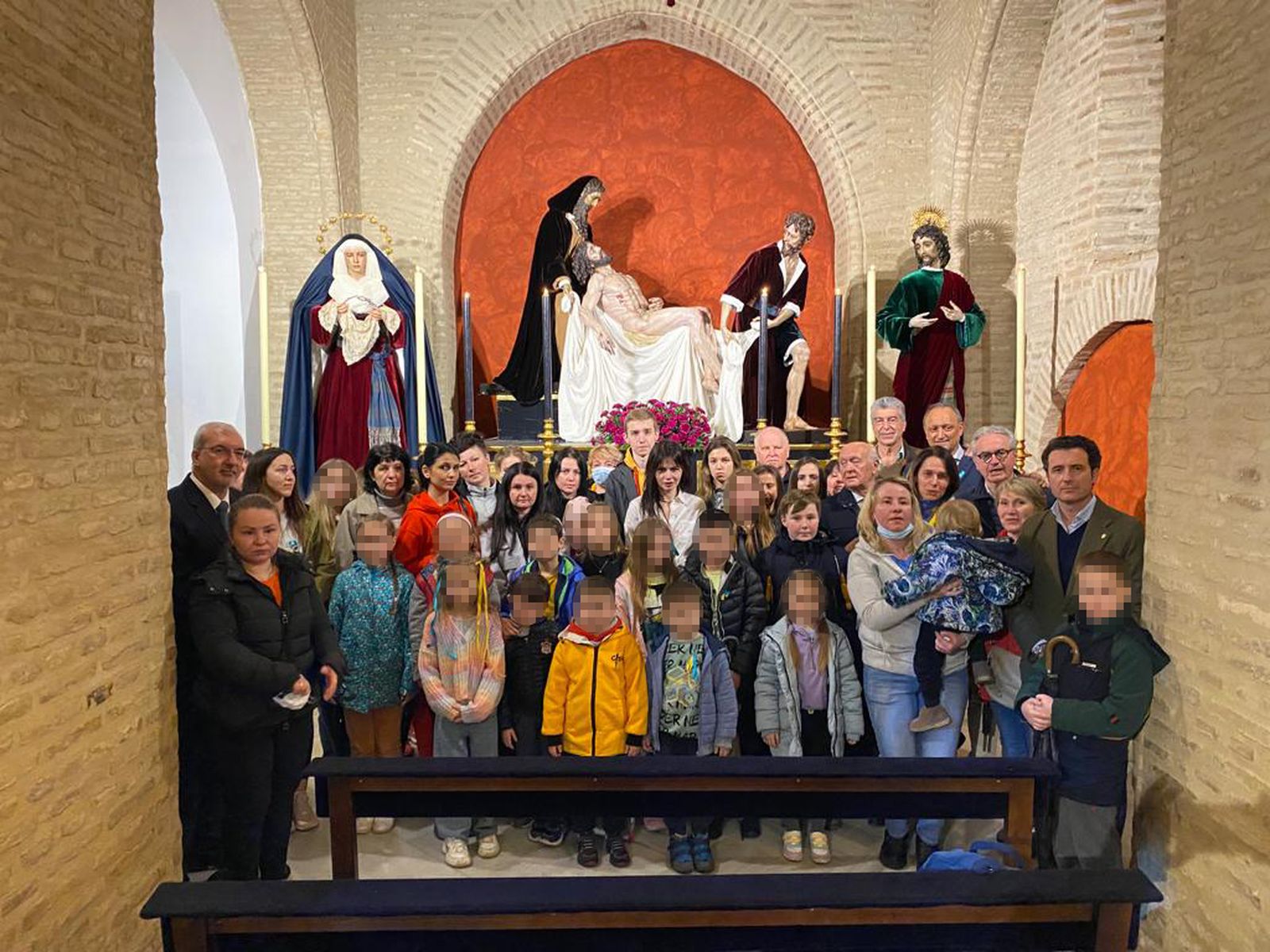 El primer grupo de refugiados ucranianos acogidos por la hermandad, ante sus titulares.