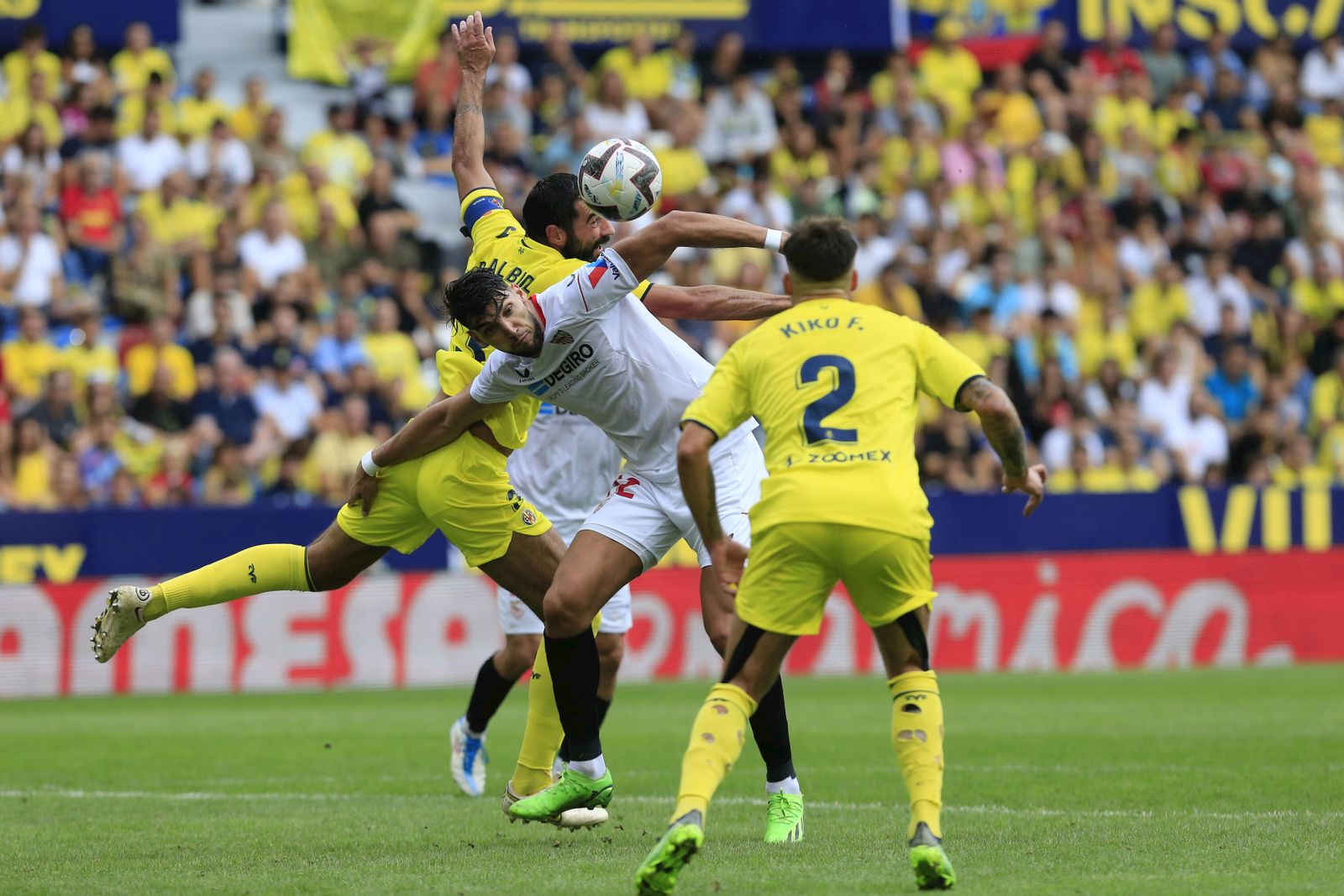 Rafa Mir pugna con Raúl Albiol ante Kiko Femenía en el Villarreal-Sevilla de la primera vuelta.