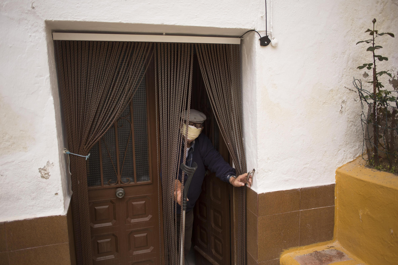 Un vecino de la Serranía rondeña se asoma a la puerta de su casa.