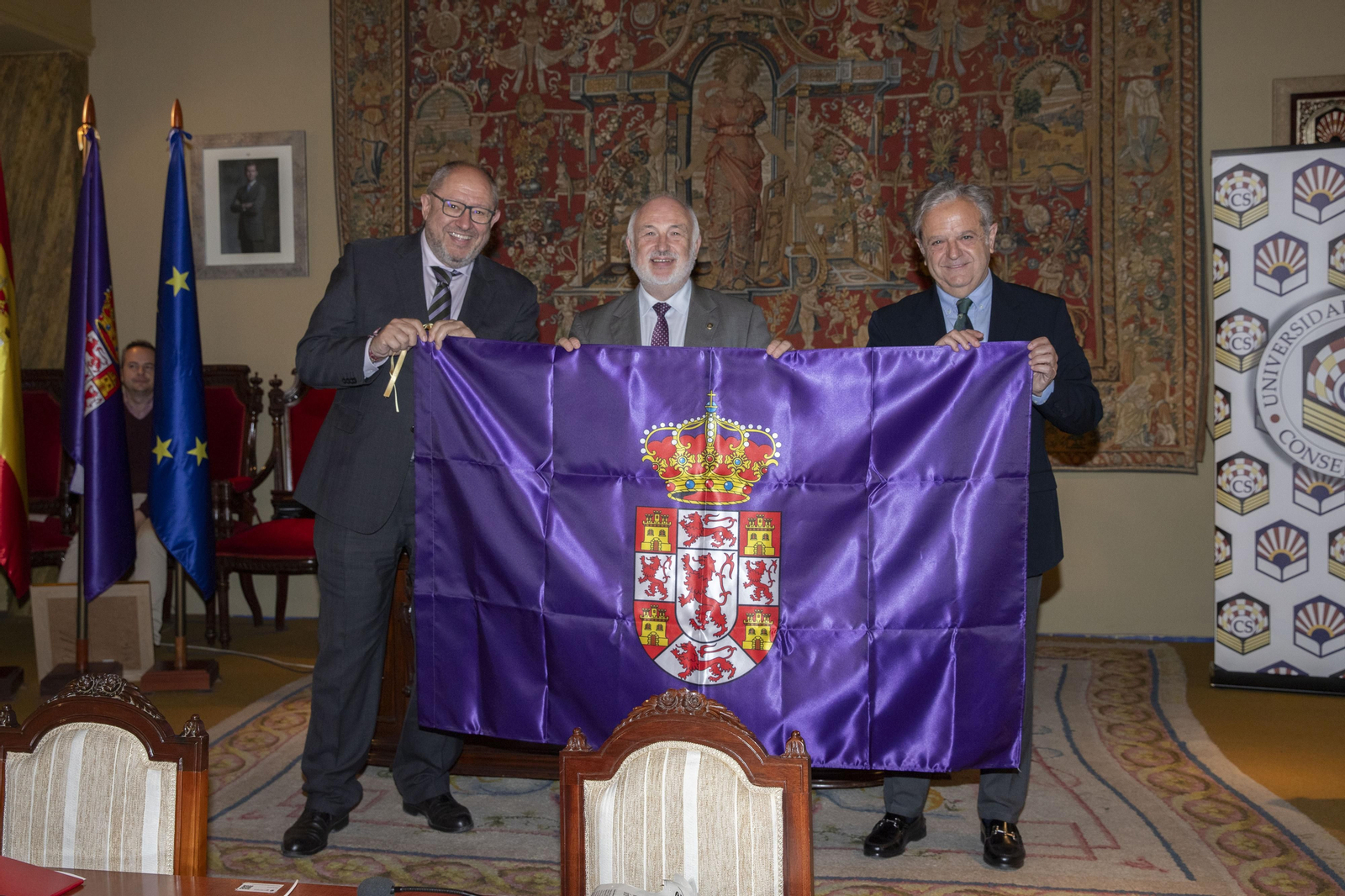 Salvador Fuentes entrega la bandera de la provincia a Manuel Torralbo y Francisco Muñoz Usano.
