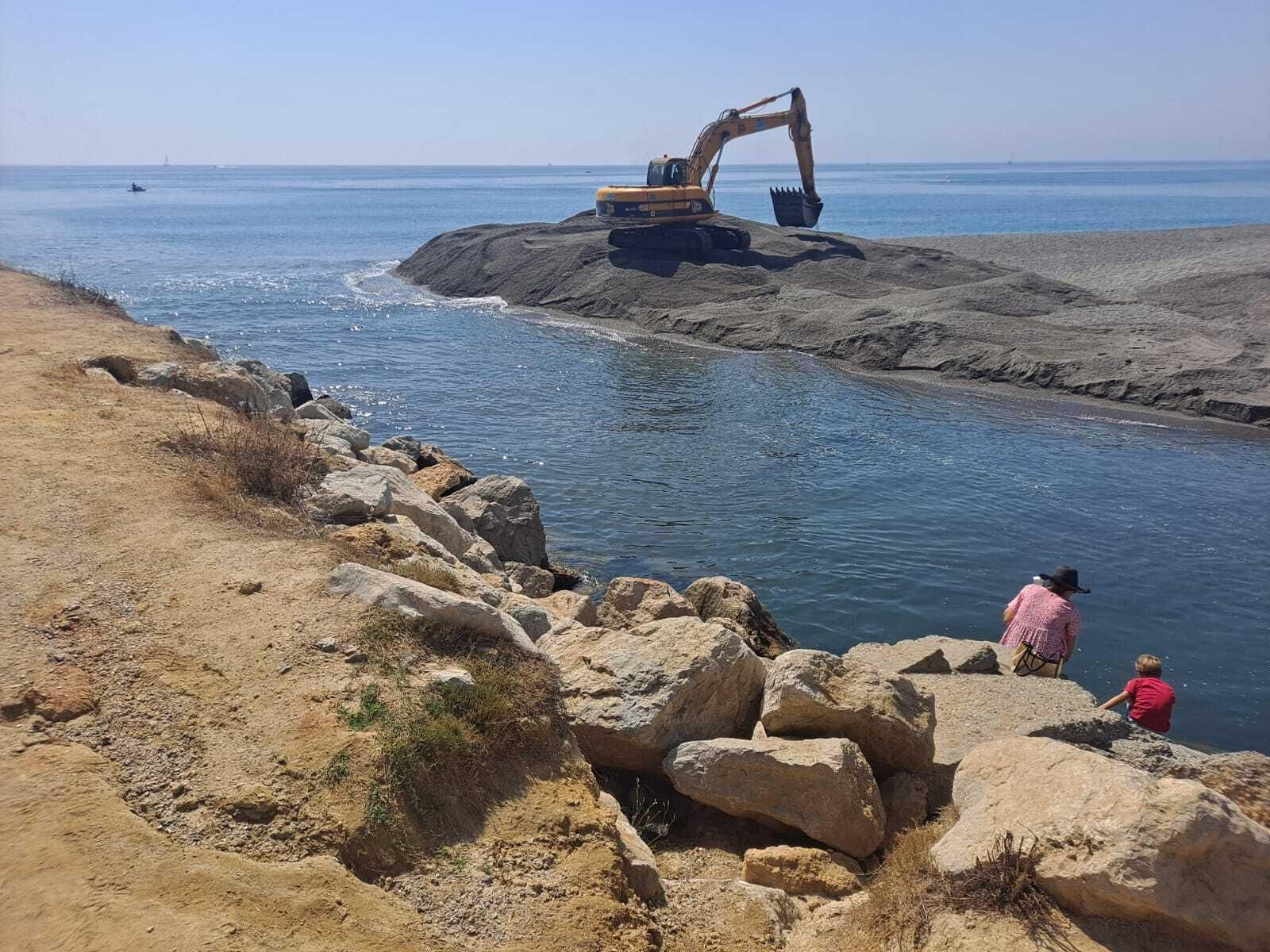 Una excavadora retira arena de la desembocadura del Guadiaro, este viernes.