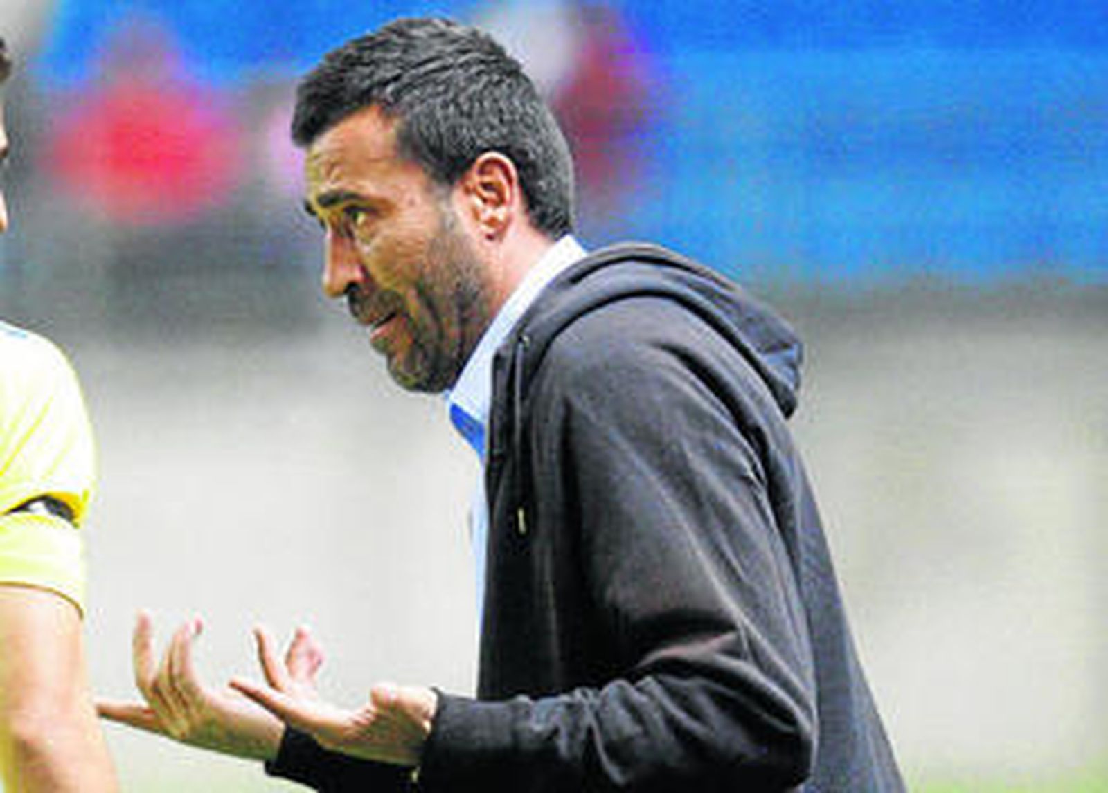 Raúl Agné abre las manos tratando de explicar algún concepto a uno de sus jugadores.