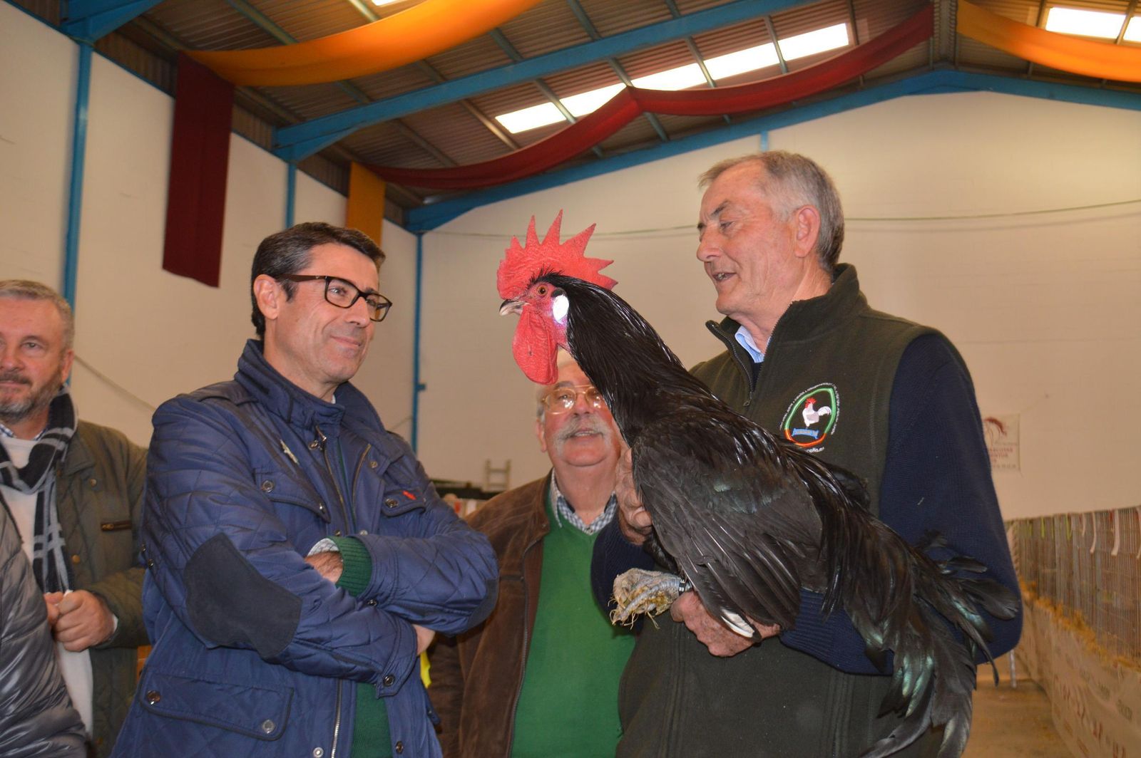 Visitantes del concurso con una de los gallos.