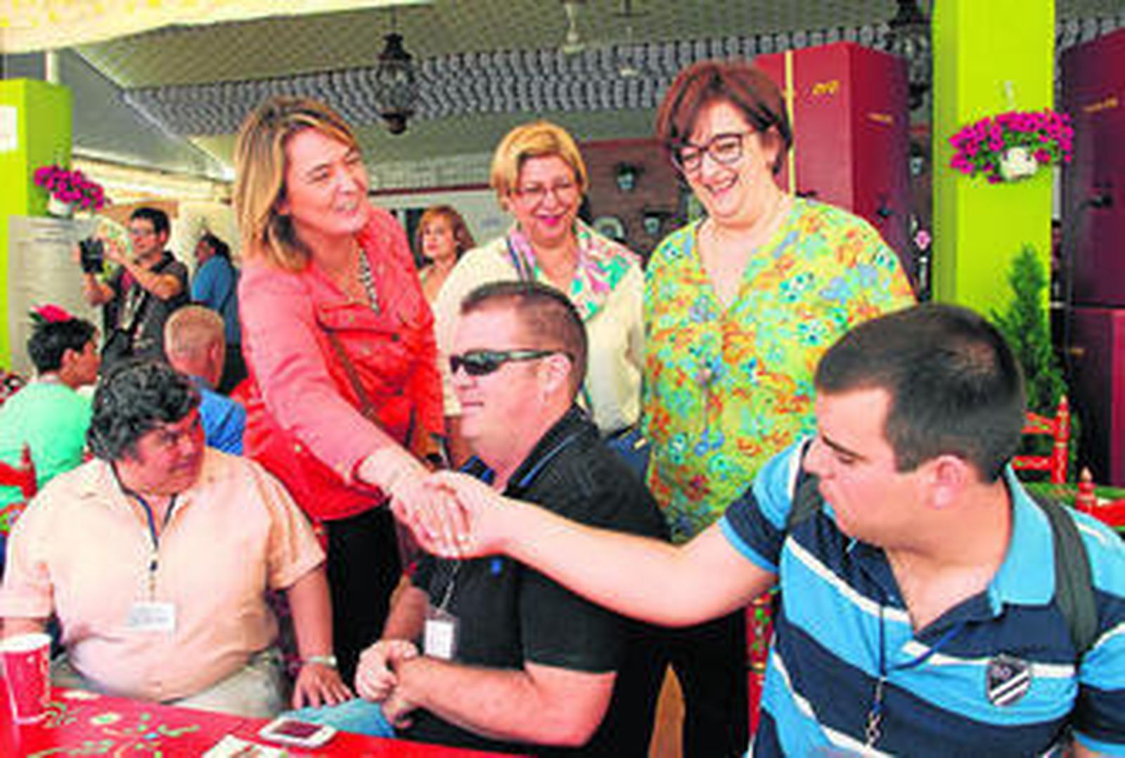 Luisa García Chamorro saluda a uno de los comensales, ayer durante el almuerzo en la caseta de la Diputación.