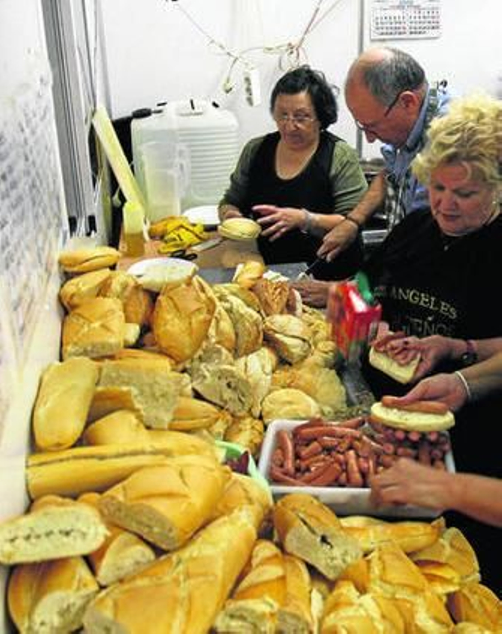 Voluntarios preparan los bocadillos que después dan a los más necesitados.