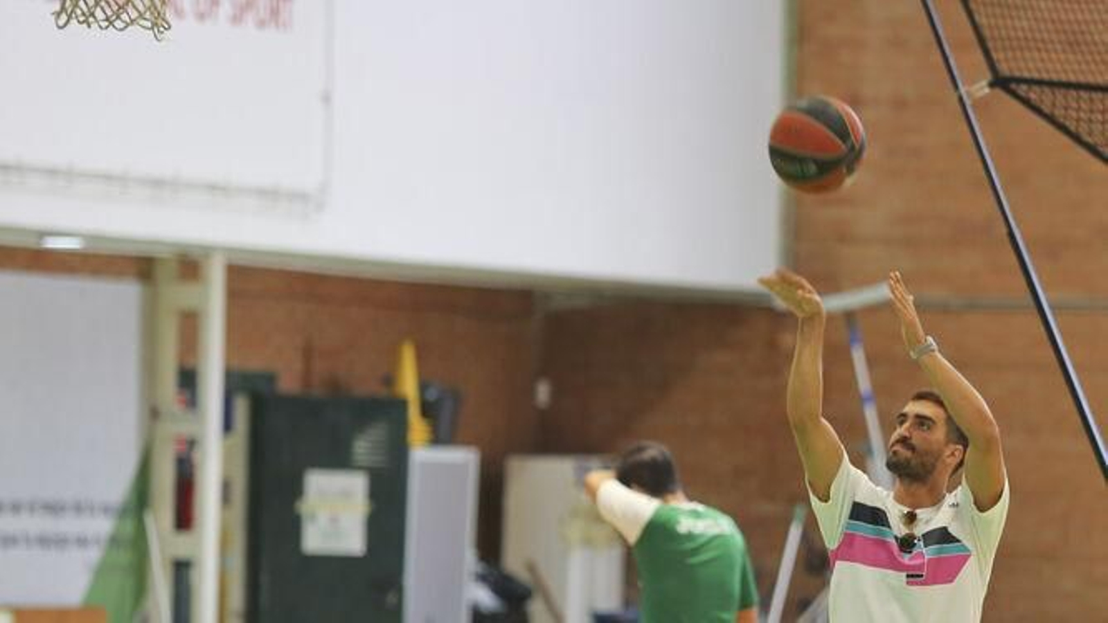 Jaime Fernández, con ropa de calle, lanza a canasta.