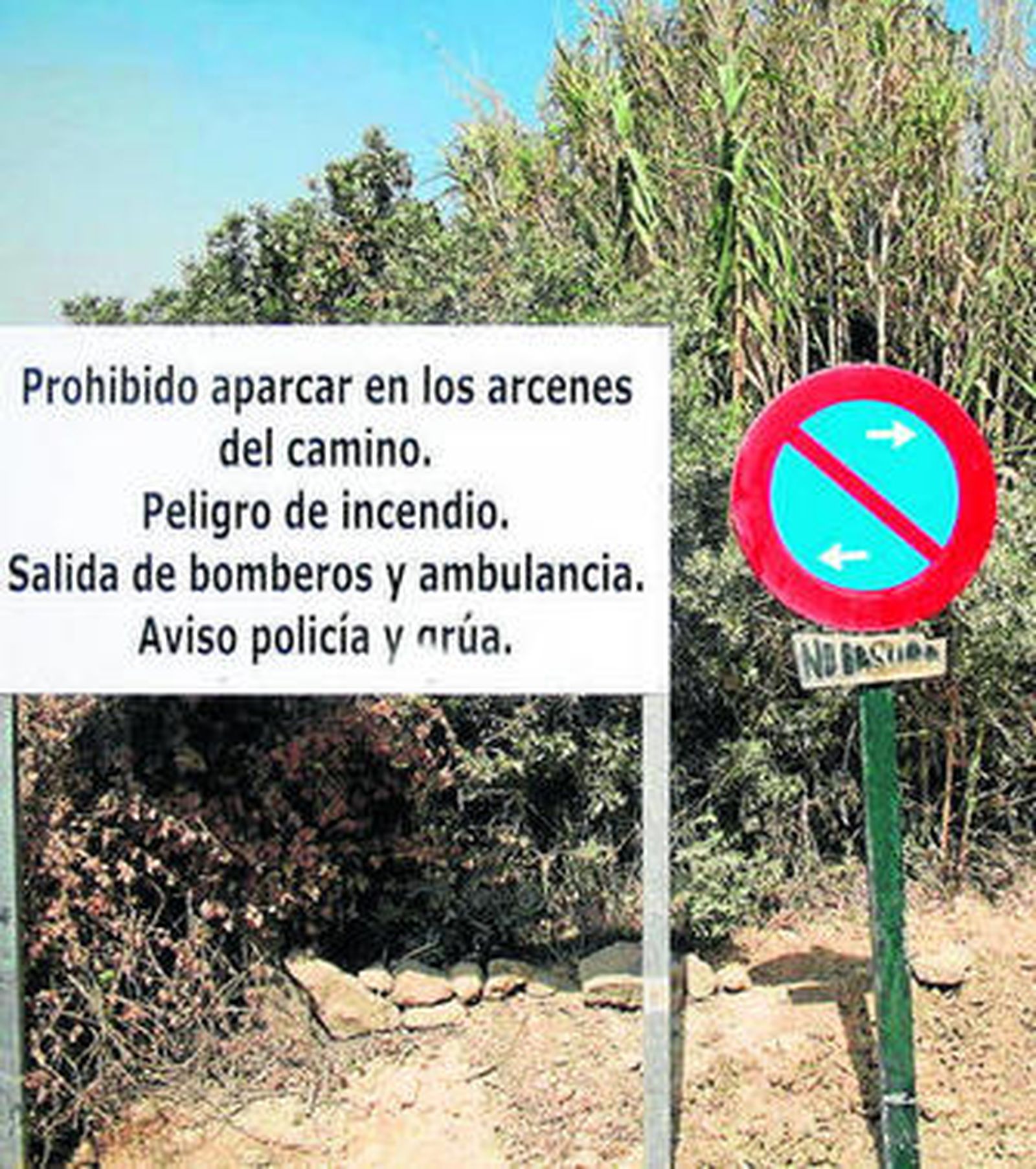 El camino de acceso, con un cartel que anuncia del peligro de incendio.