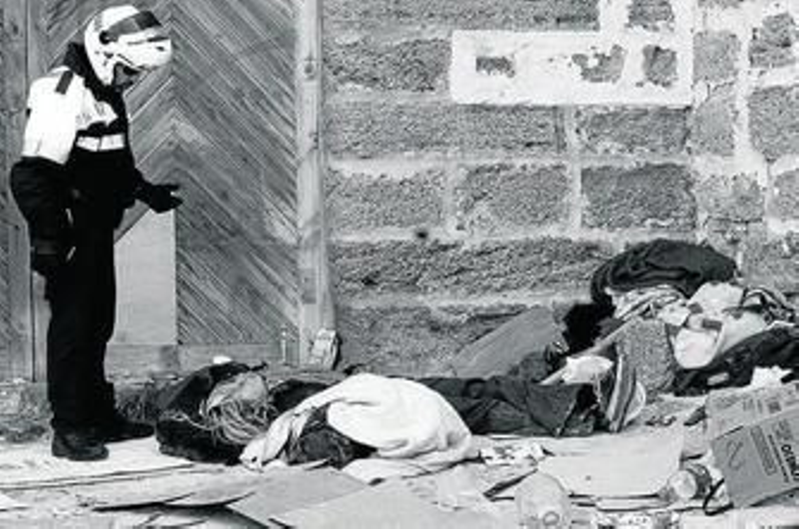 Un agente de la Policía Local desaloja a una persona en el foso de las Puertas de Tierra.