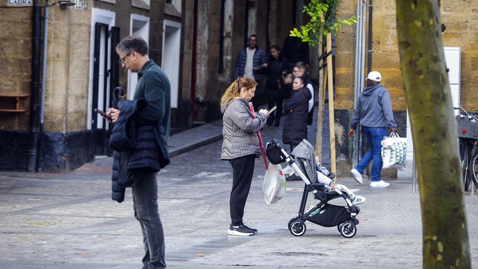 Peatones haciendo uso del teléfono móvil en la calle