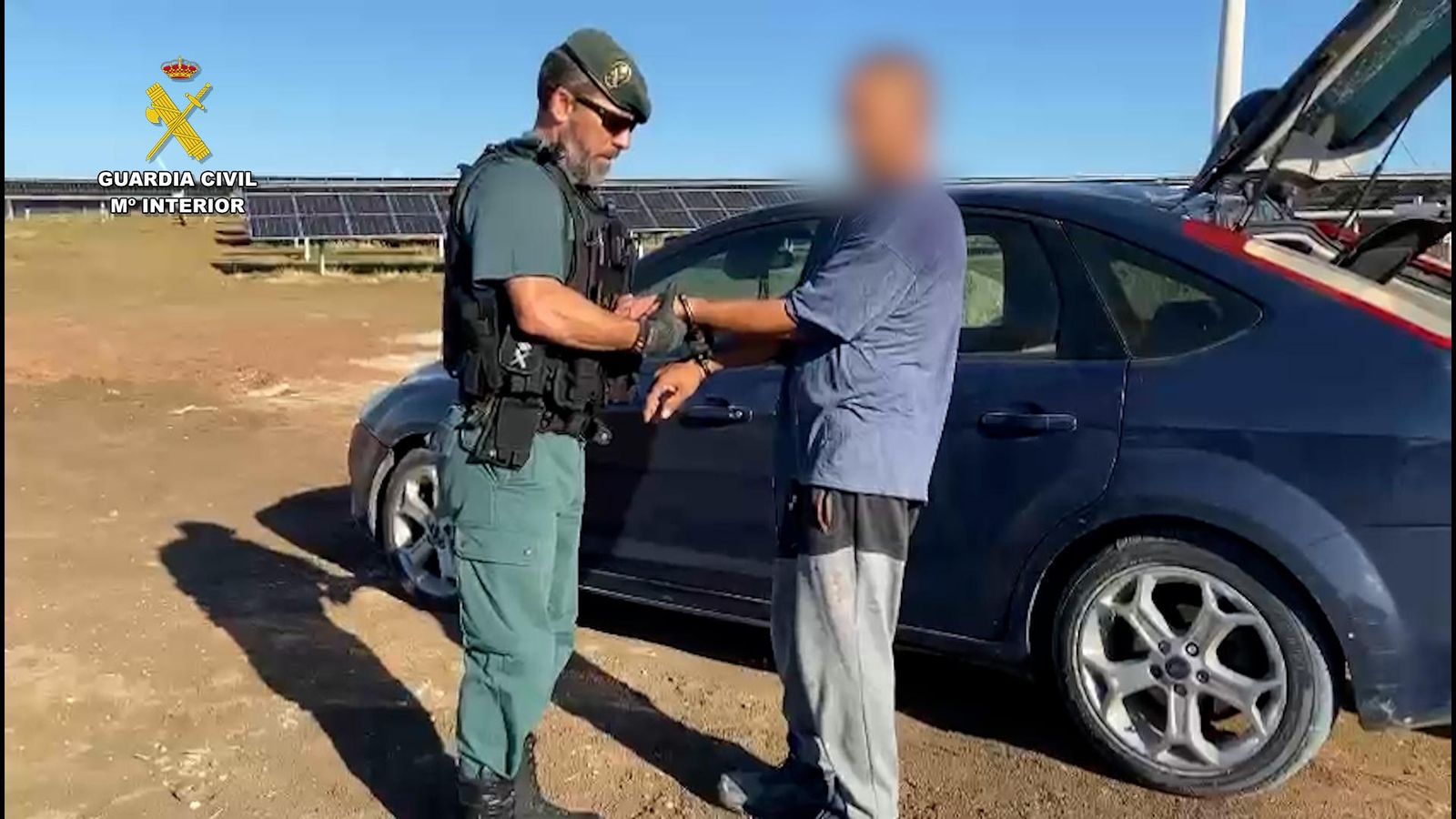 Un agente de la Guardia Civil, con uno de los detenidos. Un agente de la Guardia Civil, con uno de los detenidos.