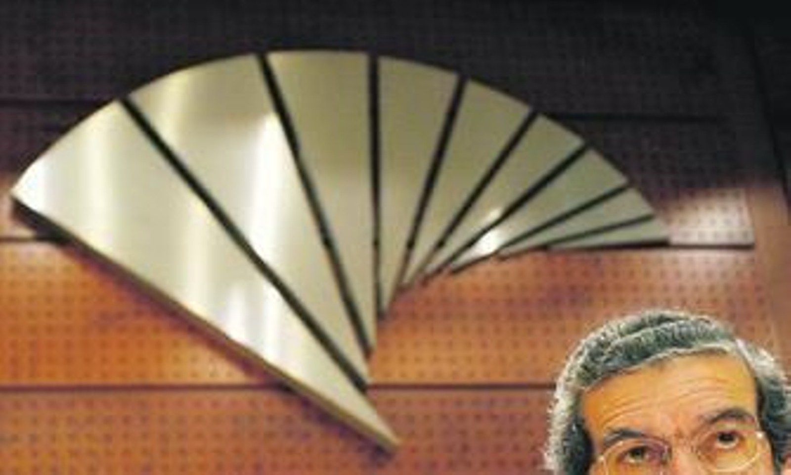 Braulio Medel, presidente de Unicaja, bajo el logotipo de la entidad en una imagen de archivo.