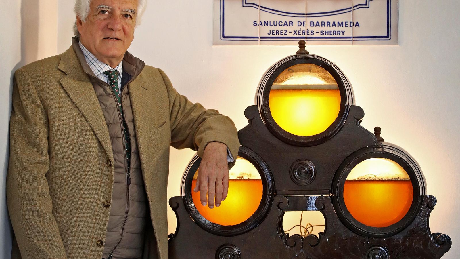 El bodeguero junto a las botas que sirven para mostrar a los visitantes la crianza bajo velo de flor de la Manzanilla de Sanlúcar.