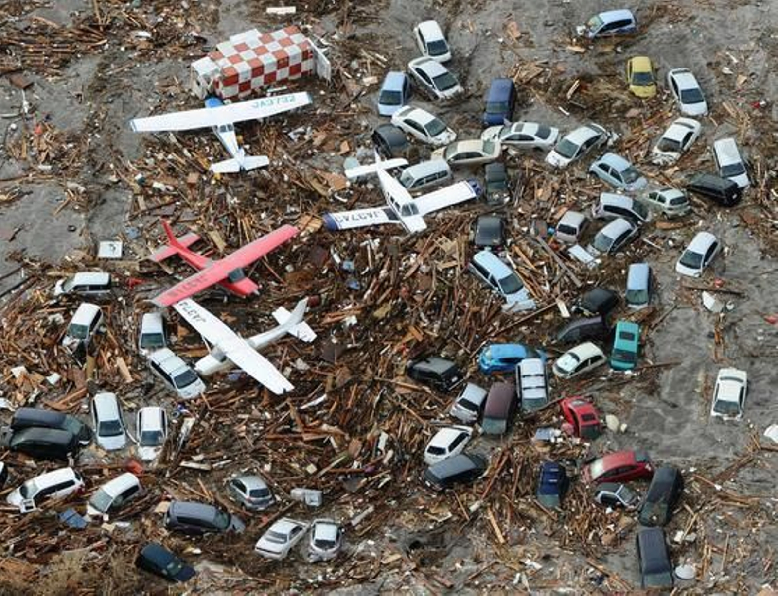 Coches y avionetas destrozadas tras el fuerte 'tsunami' en Japón.

Foto: STR
