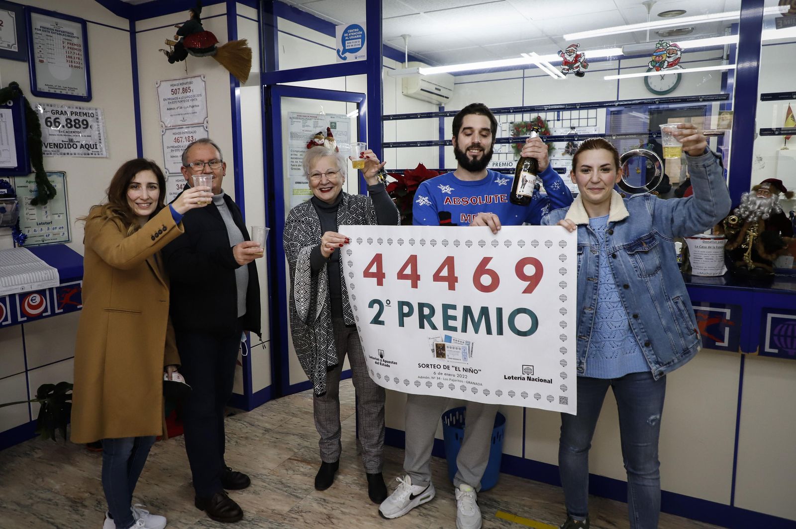 Varias personas celebran el segundo premio en una administración de loterías.
