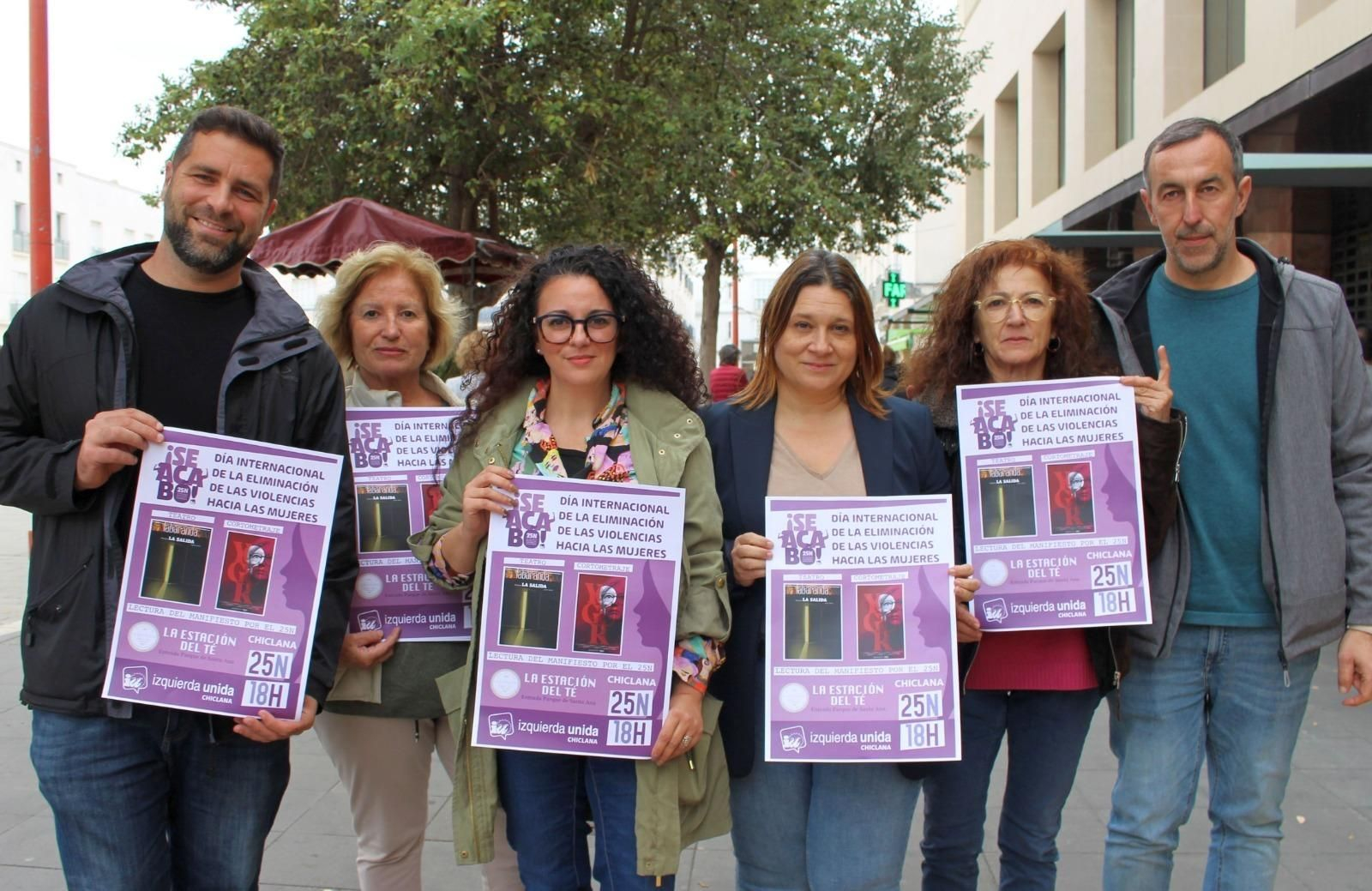Representantes de Izquierda Unida, con el cartel anunciador de los actos del 25N.