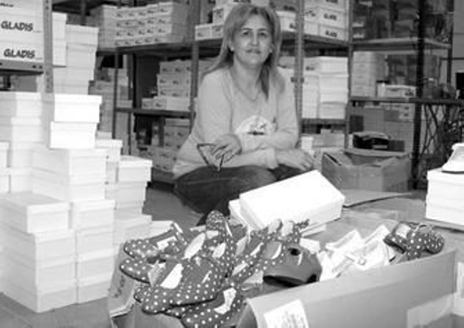La presidenta de Apical, Marisa Fernández, rodeada de los zapatos que se fabrican en su fábrica 'Gladis' en Valverde del Camino.
