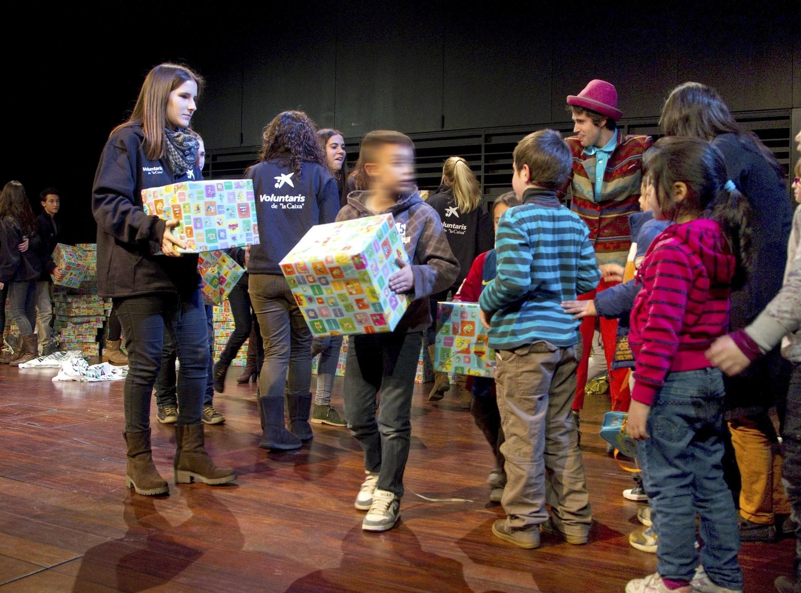 Niños recogiendo sus regalos, dentro del programa CaixaProinfancia.