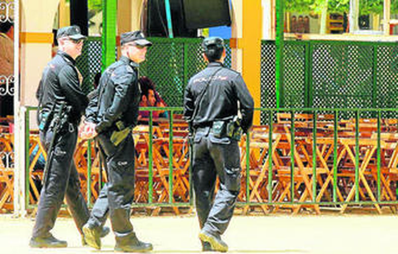 Tres agentes del Cuerpo Nacional de Policía patrullan por uno de los paseos del parque González Hontoria.