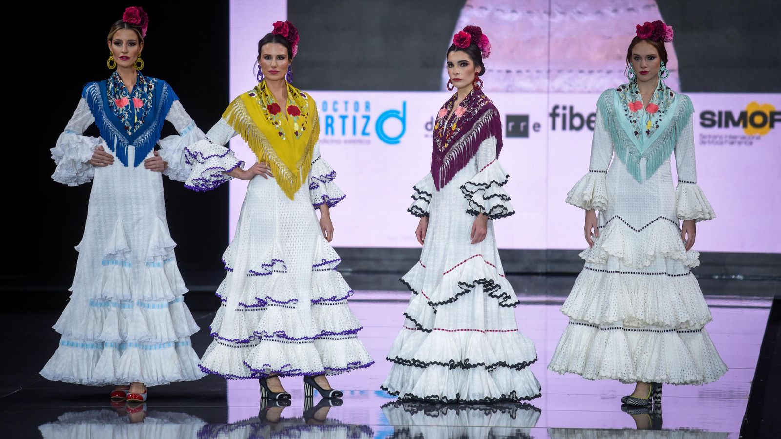 Trajes de flamenca blancos vistos en la colección de MiAbril. Trajes de flamenca blancos vistos en la colección de MiAbril.