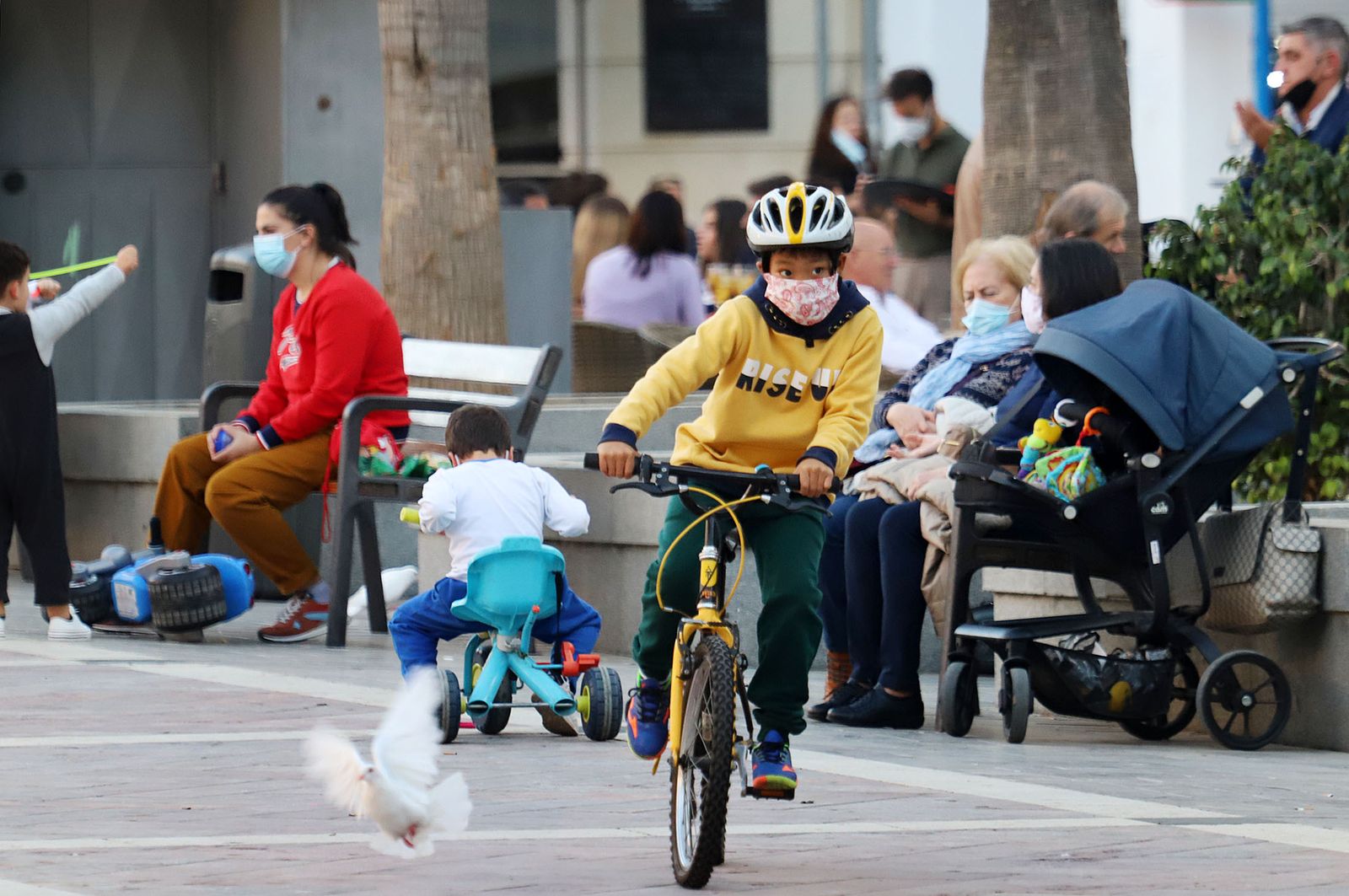 Gente con mascarillas en un parque de Huelva.