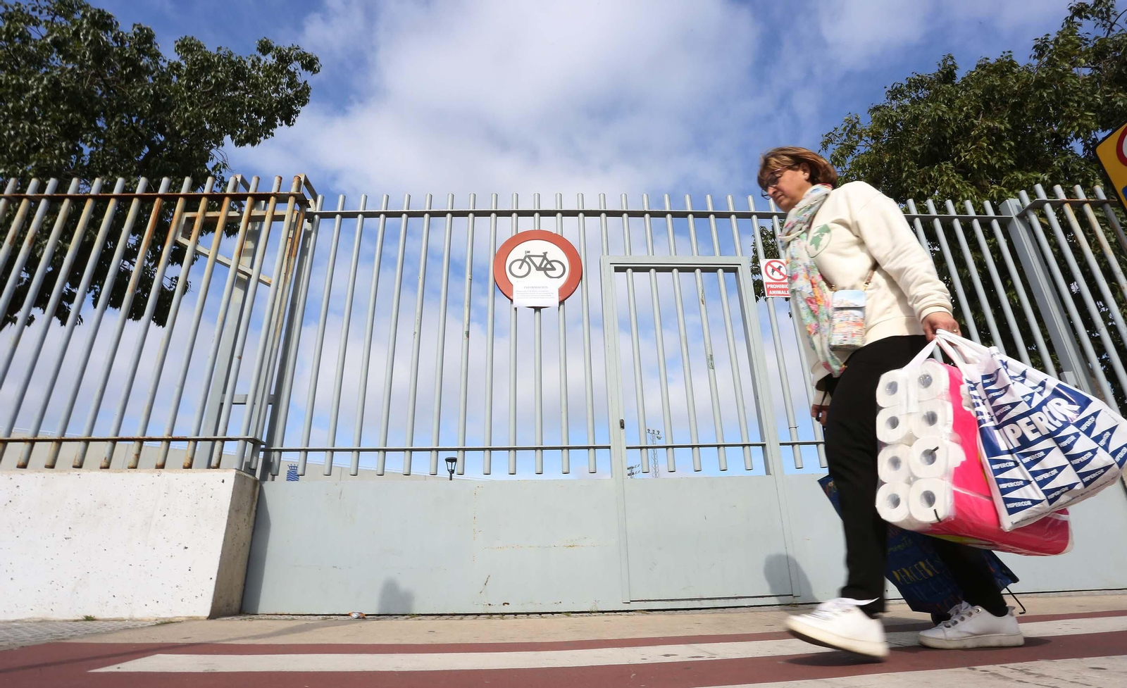 Una mujer camina con bolsas de la compra por la ciudad.