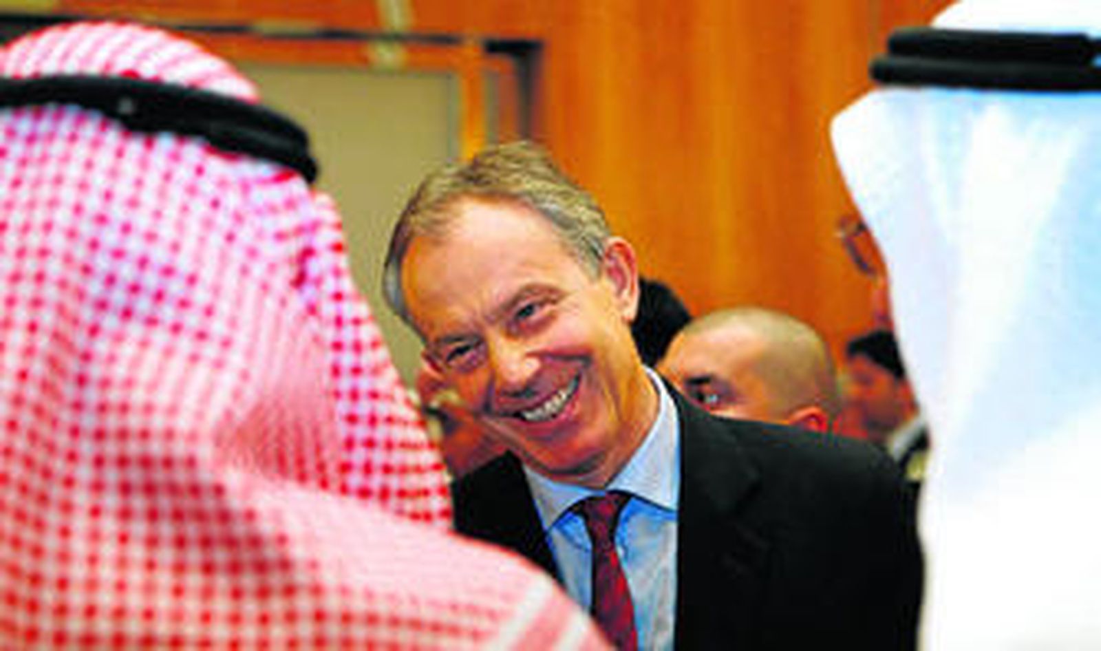 El enviado del Cuarteto para Oriente Próximo y ex 'premier' británico Tony Blair habla con dos hombres durante un encuentro en Kuwait.
