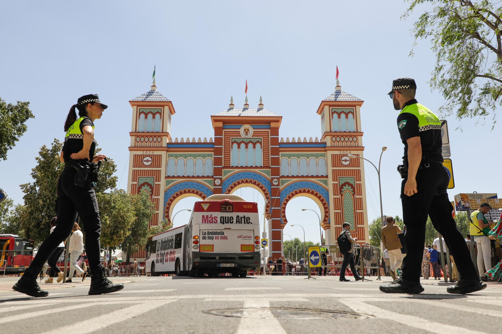 Una pareja de policías locales frente a la portada de la Feria de 2024.