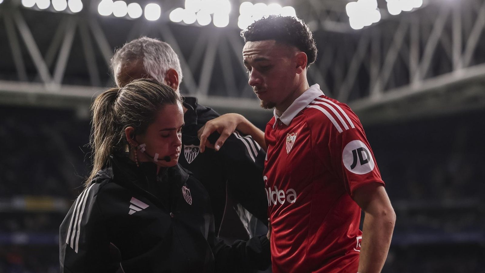 Rubén Vargas, cariacontecido, abandona el césped de Cornellá ayudado por los sanitarios.