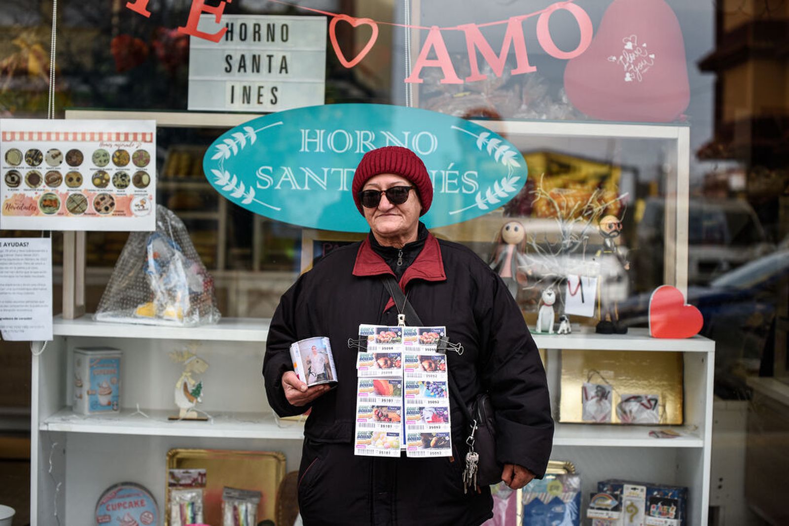 Una mujer vende cupones en una calle de Huelva en la mañana de este domingo