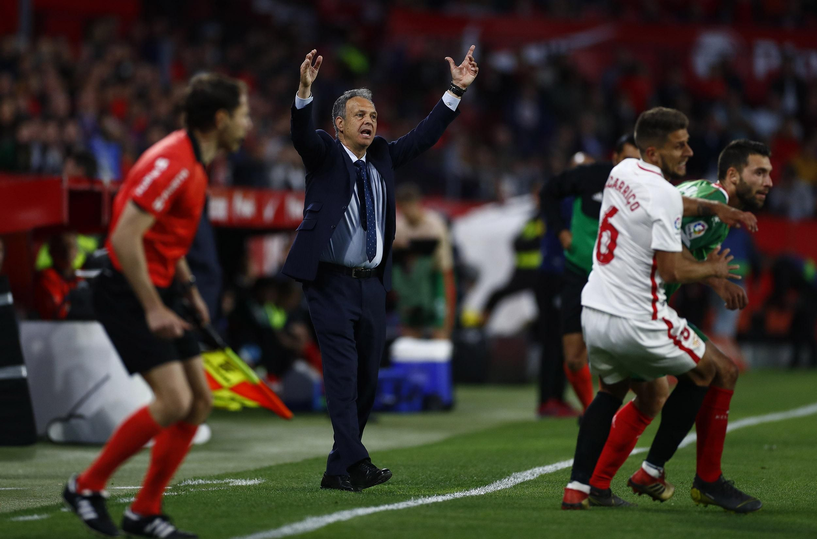 Caparrós alza los brazos haciendo una reclamación ante el línea y mientras Carriço hostiga a Borja Bastón.