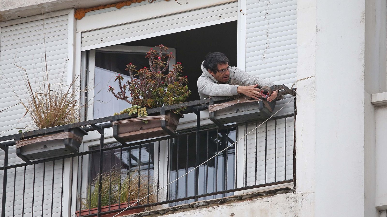 Un vecino refuerza las macetas de su balcón en Algeciras.