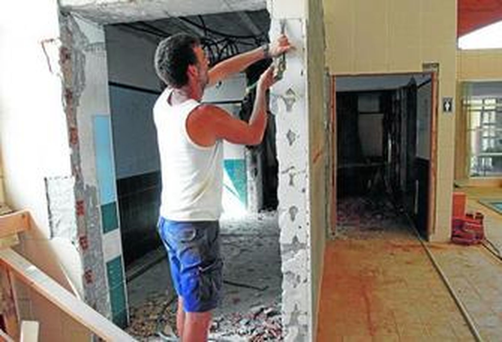 Un hombre trabaja en la remodelación de un edificio.