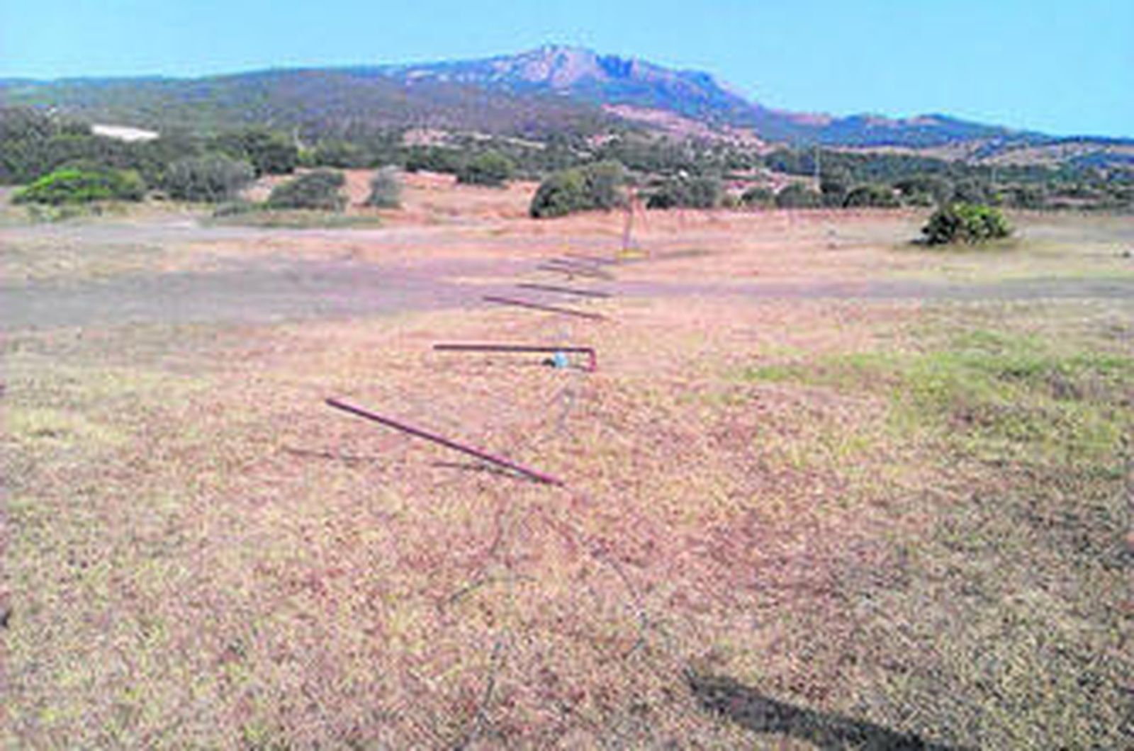 Imagen de la valla perimetral del aparcamiento derribada, ayer, en la zona de Casa de Porros.