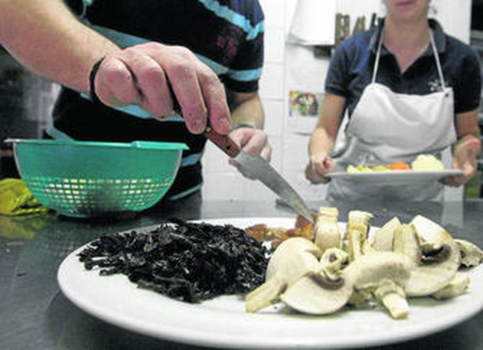 Los cocineros del restaurante Anón de Jimena muestran un plato con champiñones, trompetas de la muerte y otras variedades.